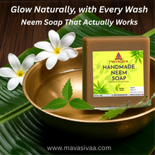 Load image into Gallery viewer, Mavasiva handmade neem soap with flowers and leaves on a wooden background